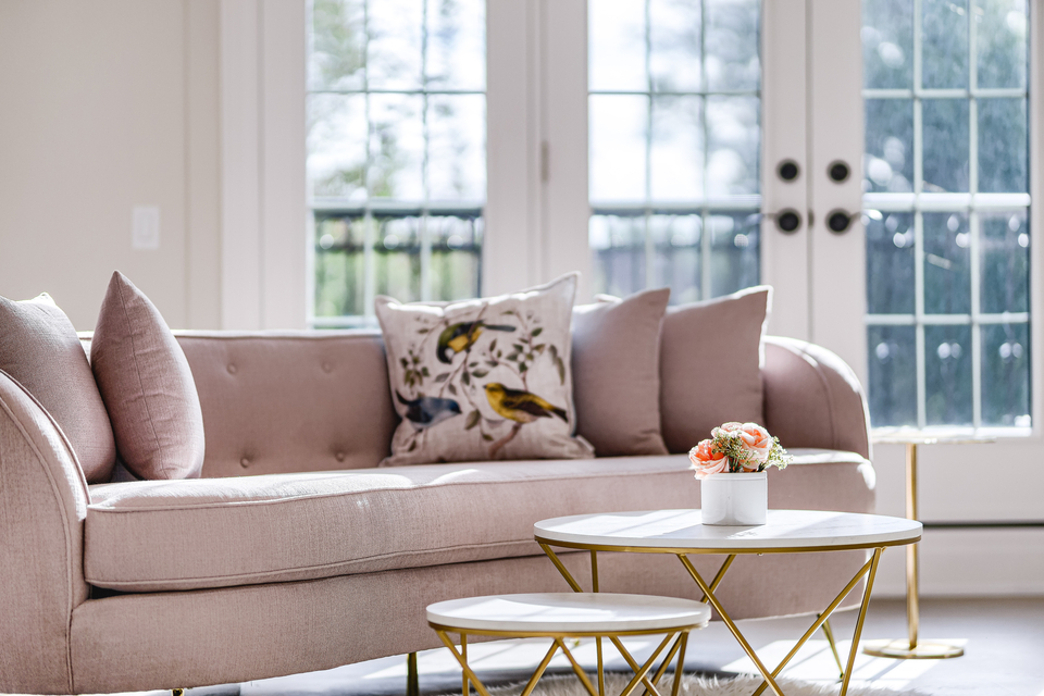 Pink couch with zoomed in table and flowers